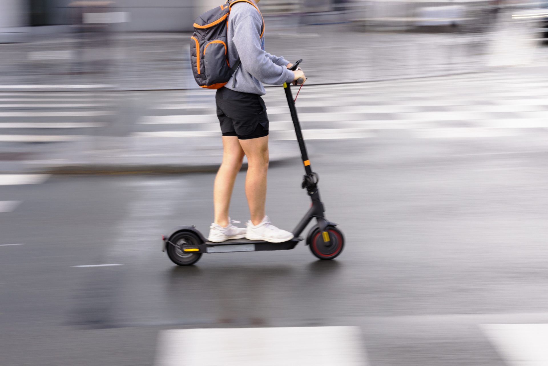 motion blur picture of a person with an electric scooter on a city street motion blur picture of a person with an electric scooter on a city street