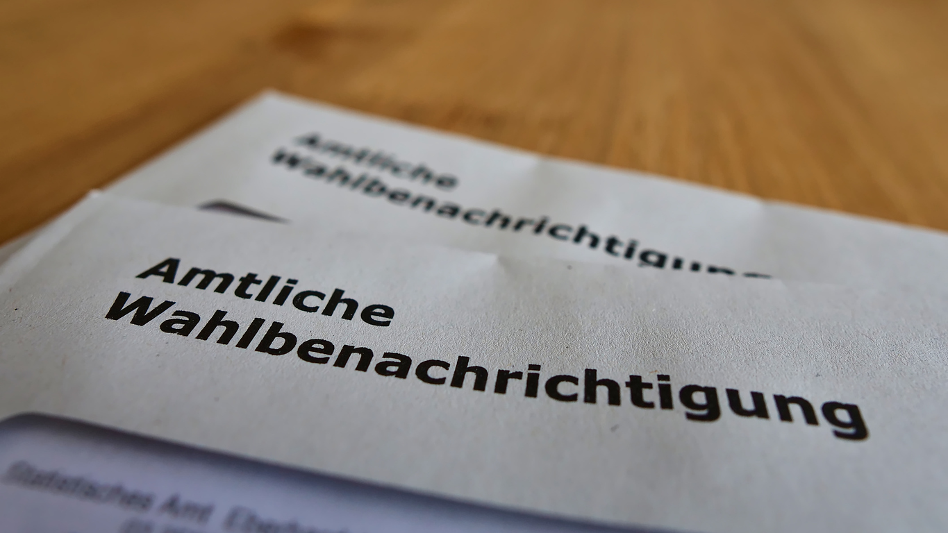 Closeup view of two letters with official polling cards (in German on envelope: "amtliche Wahlbenachrichtigung") for the parliamentary elections (Bundestag) in 2021.