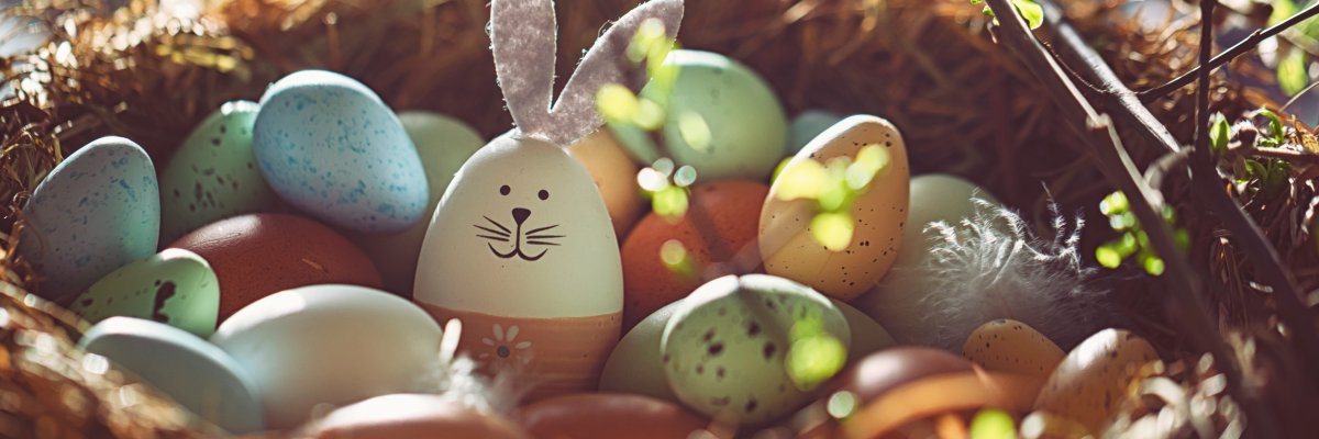 Easter decoration with crafted Easter bunny in the sunny nest