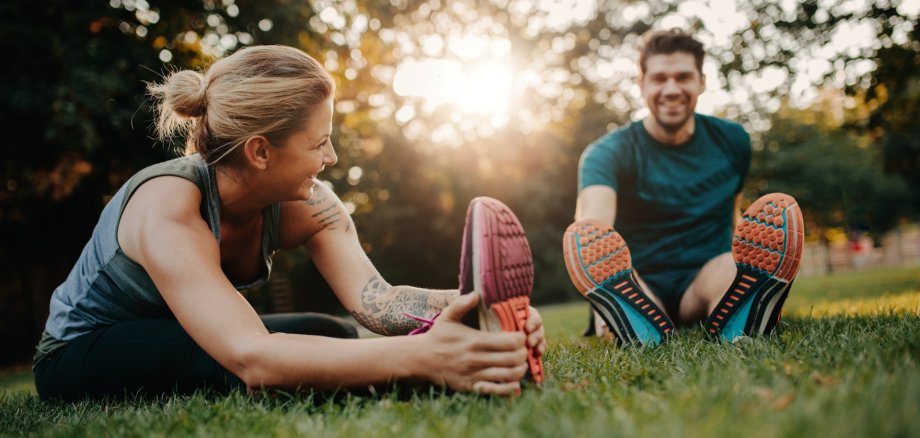 Young couple doing their stretches in the park