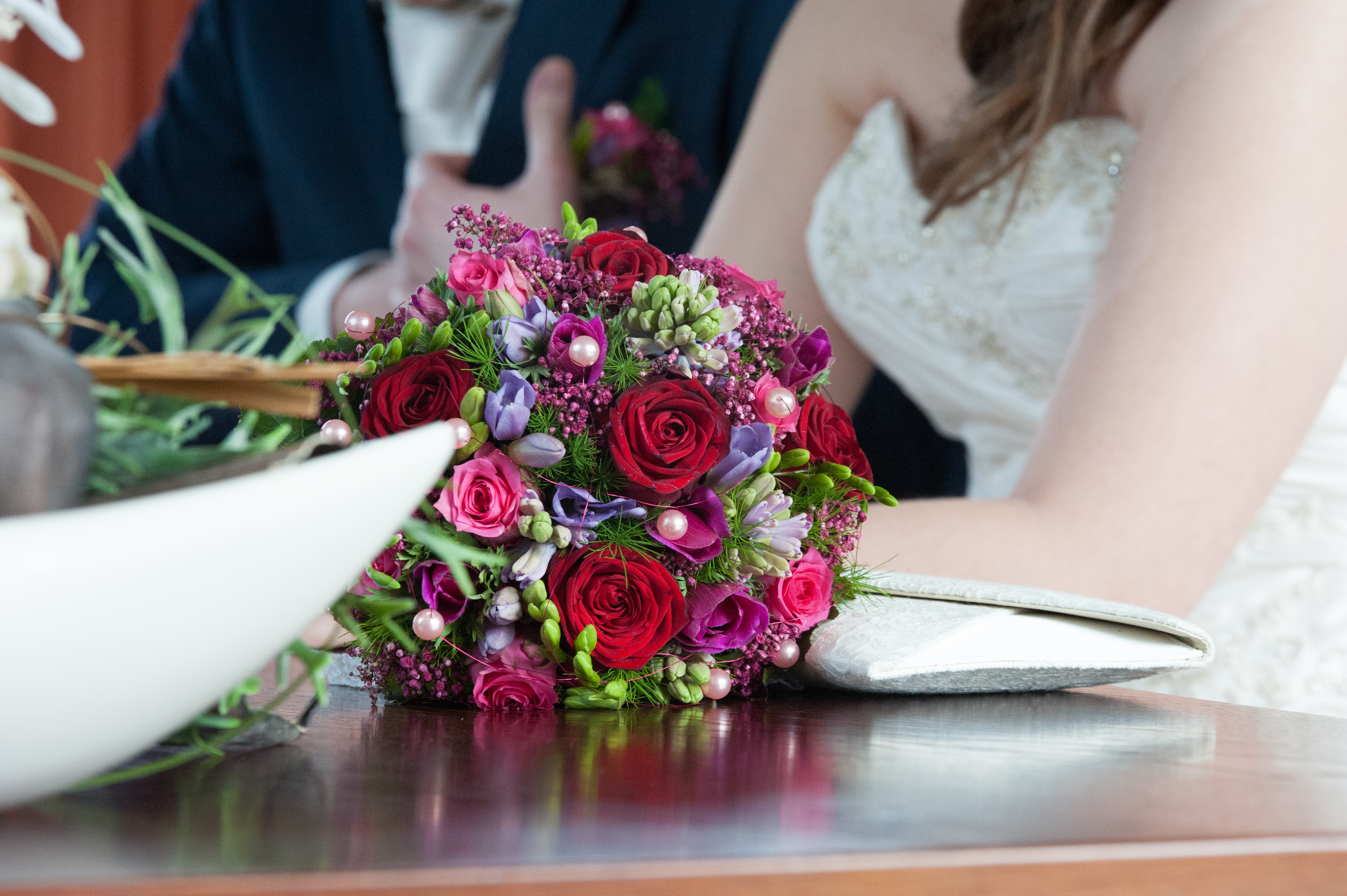 A bridal couple, a wedding and a bridal bouquet
