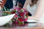 A bridal couple, a wedding and a bridal bouquet