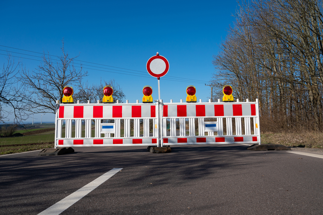 Barrier system for building site protection on a damaged road, prohibited zone, warning sign, closed broken street in Trier, Germany Barrier system for building site protection on a damaged road, prohibited zone, warning sign, closed broken street in Trier, Germany