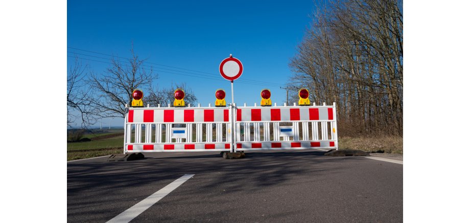 Barrier system for building site protection on a damaged road, prohibited zone, warning sign, closed broken street in Trier, Germany Barrier system for building site protection on a damaged road, prohibited zone, warning sign, closed broken street in Trier, Germany